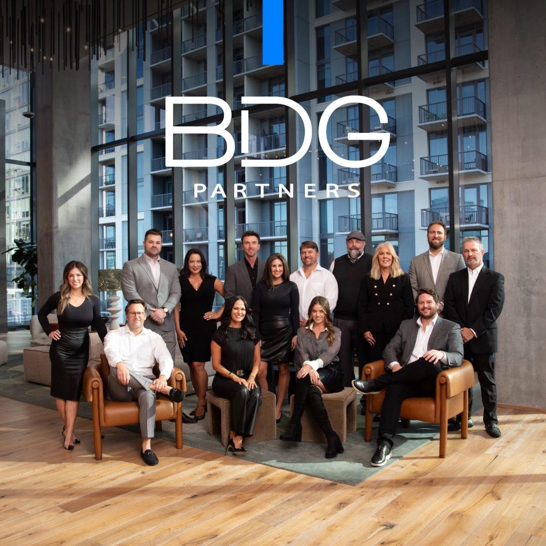 BDG Group team members standing together and smiling during a team photo session.